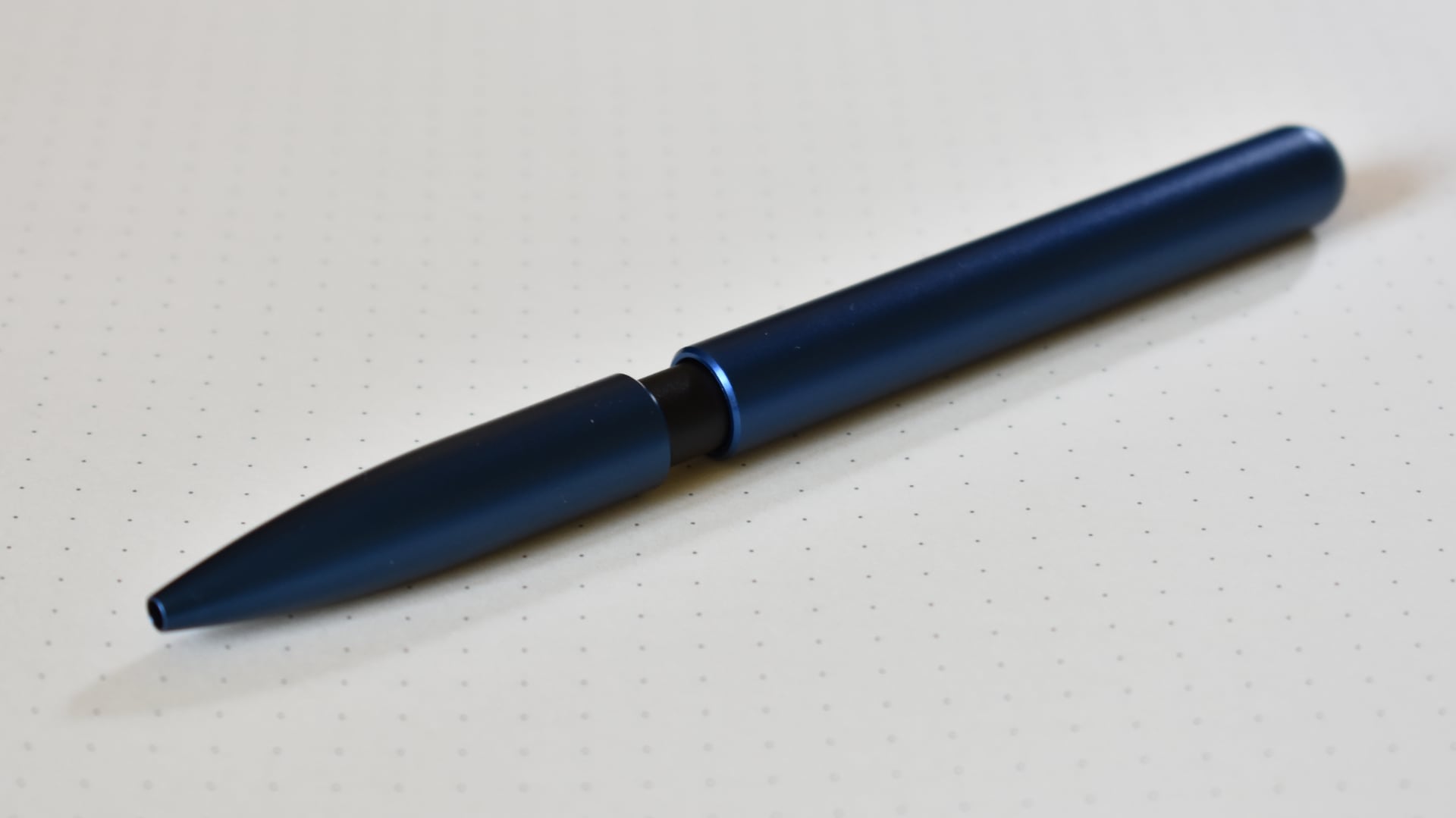 The pen, with the cap covering the refill cartridge